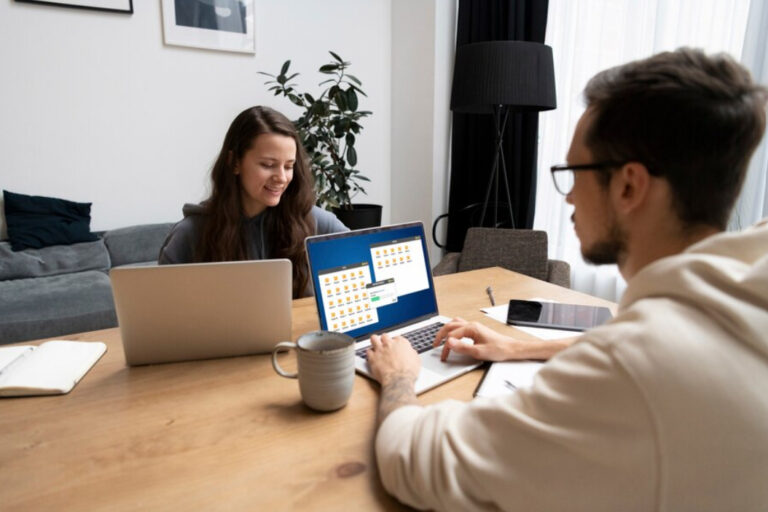 How To Run Google Ads For Clients. An image of a Couple at desk working together from home